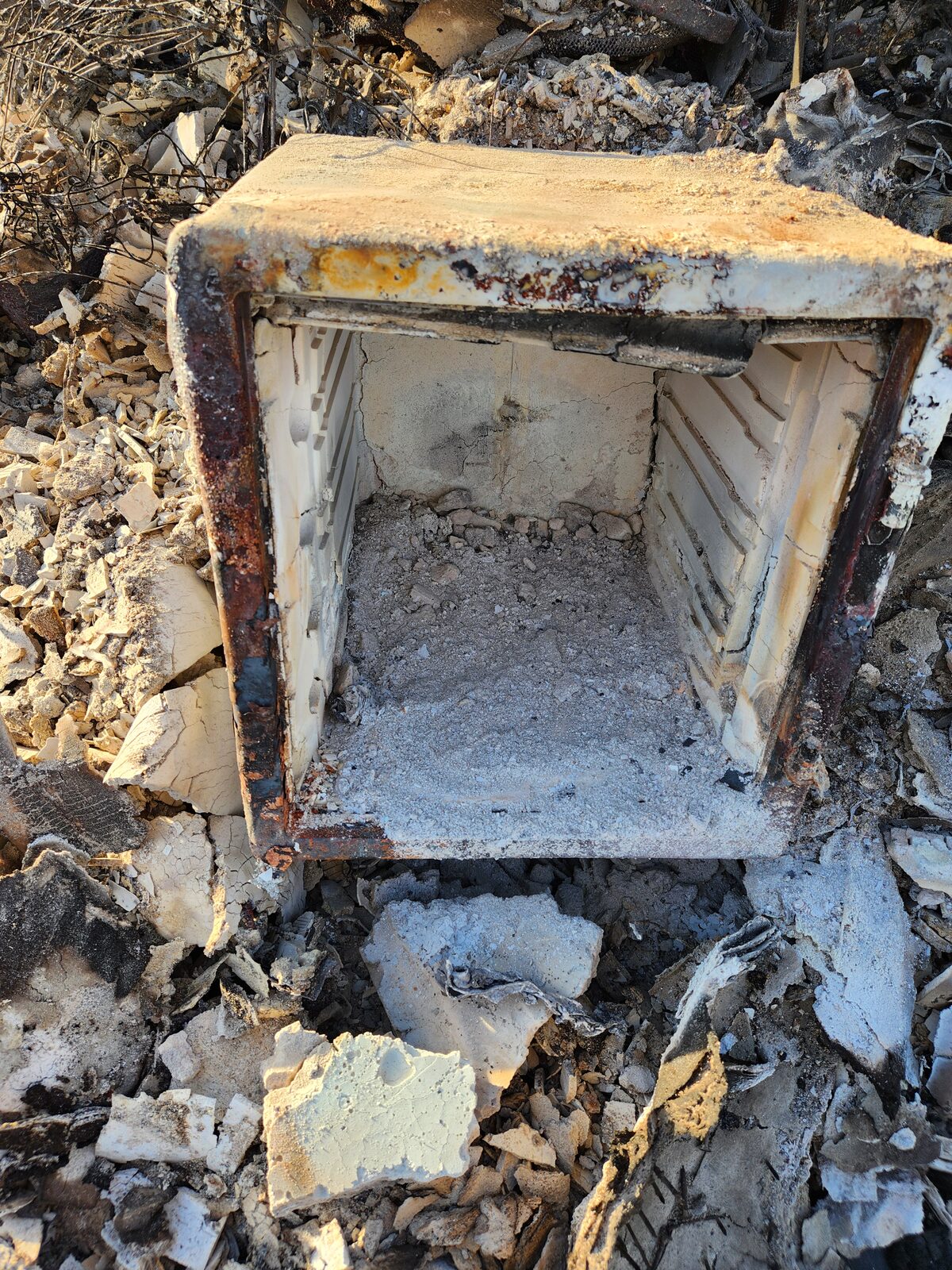 A fireproof safe burned and warped by the Eaton Fire, its lid scorched and its contents destroyed — the backup that was supposed to survive, didn't.